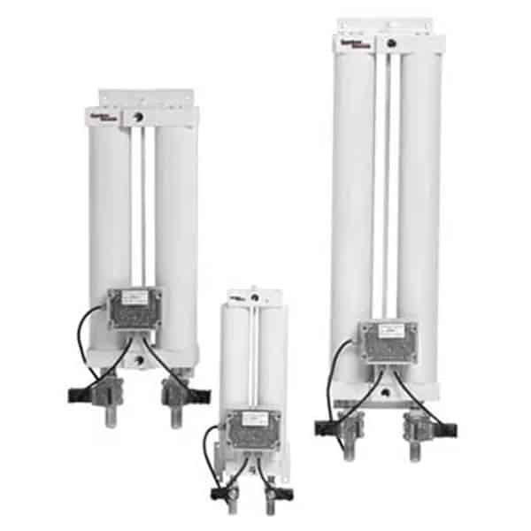 Three industrial air dryers with vertically mounted cylindrical white tanks in different sizes, featuring control boxes and piping below.