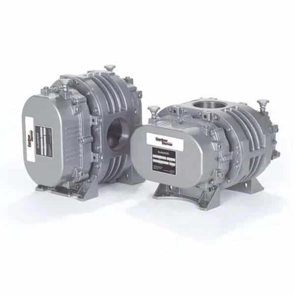 Two industrial rotary blowers with metallic gray casings stand side by side, each with labeled plates and solid mounting bases.