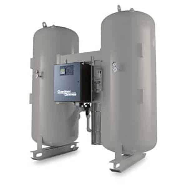 Two large, upright cylindrical industrial tanks connect to a central control panel labeled Gardner Denver, with pipes and gauges on metal supports.